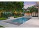 Backyard features a rectangular pool, in-ground spa, fire pit, privacy fence, and tropical landscaping at 1820 Glencoe Rd, Winter Park, FL 32789