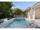 Inviting swimming pool with a jacuzzi and lounging chairs set against lush greenery, offering a serene retreat at 1820 Glencoe Rd, Winter Park, FL 32789