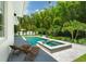Backyard featuring a pool and spa surrounded by lush landscaping, creating a private oasis for relaxation at 1820 Glencoe Rd, Winter Park, FL 32789