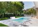 Beautiful pool area featuring lush greenery, a built-in spa, and ample space for outdoor relaxation at 1820 Glencoe Rd, Winter Park, FL 32789