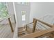 Modern staircase with wood treads, stainless steel railings, and natural light from large windows at 1820 Glencoe Rd, Winter Park, FL 32789