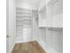 Spacious walk-in closet with custom shelving and drawers for optimal organization at 1820 Glencoe Rd, Winter Park, FL 32789