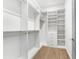 Spacious walk-in closet with custom shelving and drawers for optimal organization at 1820 Glencoe Rd, Winter Park, FL 32789