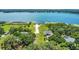 Stunning aerial view of a lakeside home with private beach access and mature trees at 19554 Spring Oak Dr, Eustis, FL 32736