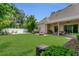 Lush backyard with manicured lawn, perfect for outdoor entertaining and relaxation, featuring a fire pit and patio at 19554 Spring Oak Dr, Eustis, FL 32736