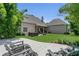 Beautiful backyard with covered patio, lush greenery, and a fire pit, offering a serene outdoor living space at 19554 Spring Oak Dr, Eustis, FL 32736