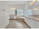 Primary bath features tile floor, vanity, and tub with glass block window at 19554 Spring Oak Dr, Eustis, FL 32736