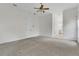 Carpeted bedroom featuring a ceiling fan, natural light, and ensuite bath at 19554 Spring Oak Dr, Eustis, FL 32736