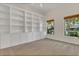 Versatile bonus room featuring built-in shelving and large windows, perfect for a home office or library at 19554 Spring Oak Dr, Eustis, FL 32736