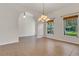 Bright dining room featuring tiled floors, natural light, and an elegant chandelier at 19554 Spring Oak Dr, Eustis, FL 32736