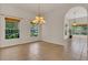 Bright dining room featuring tiled floors, natural light, and an elegant chandelier at 19554 Spring Oak Dr, Eustis, FL 32736
