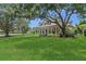 Charming home with lush front yard and mature trees, enhancing its curb appeal and creating a welcoming atmosphere at 19554 Spring Oak Dr, Eustis, FL 32736
