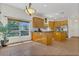 Bright and open kitchen area with tiled floors, island, wood cabinets and stainless steel appliances at 19554 Spring Oak Dr, Eustis, FL 32736