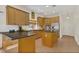 Bright kitchen featuring tiled floors, island, wood cabinets, stainless steel appliances, and breakfast bar at 19554 Spring Oak Dr, Eustis, FL 32736