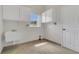 A laundry room featuring a sink, window, tile floor, and cabinets at 19554 Spring Oak Dr, Eustis, FL 32736