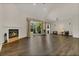 Open concept living room boasts wood floors, a fireplace and views of backyard at 19554 Spring Oak Dr, Eustis, FL 32736