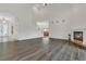 Bright living room featuring wood floors, a fireplace, and an open floor plan at 19554 Spring Oak Dr, Eustis, FL 32736