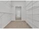 An empty walk-in closet has carpet and shelving on both sides at 19554 Spring Oak Dr, Eustis, FL 32736