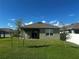 A well-manicured lawn and covered patio enhance the backyard's appeal with its outdoor space at 1982 King Ranch St, Kissimmee, FL 34744