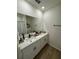Well-lit bathroom with double sinks, modern fixtures, and decorative accents at 1982 King Ranch St, Kissimmee, FL 34744