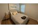 Cozy bedroom with a patterned comforter, round decorative pillows, and a bright window at 1982 King Ranch St, Kissimmee, FL 34744