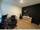 Bedroom showcasing a modern accent wall, desk, storage, and laminate flooring at 1982 King Ranch St, Kissimmee, FL 34744