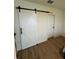 Bedroom with barn door style closet entrance, carpet, and secondary entry door at 1982 King Ranch St, Kissimmee, FL 34744