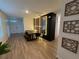 Well-lit dining area features a large wooden table, accent wall, and sleek hardwood flooring at 1982 King Ranch St, Kissimmee, FL 34744