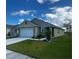 Inviting one-story residence displays a two-car garage, lush green lawn, and meticulously landscaped features at 1982 King Ranch St, Kissimmee, FL 34744