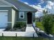 Welcoming front entrance features a walkway with landscape lighting and manicured planting beds at 1982 King Ranch St, Kissimmee, FL 34744