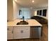 Open-concept kitchen with white cabinets and a view into the spacious living room at 1982 King Ranch St, Kissimmee, FL 34744