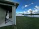 A covered patio with a hammock offers a relaxing outdoor retreat overlooking a beautiful lake at 1982 King Ranch St, Kissimmee, FL 34744