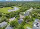 Aerial view of a neighborhood with a pond, tree-lined streets, and well-manicured lawns at 2024 Flaming Arrow Ct, Fern Park, FL 32730