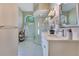 The bathroom features double sinks, sleek white cabinets, and a glass walk-in shower with tiled walls at 2024 Flaming Arrow Ct, Fern Park, FL 32730