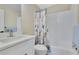 Cozy bathroom featuring a white vanity, toilet, and a bathtub with decorative shower curtain at 2024 Flaming Arrow Ct, Fern Park, FL 32730