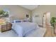 Inviting bedroom with neutral decor, a large bed, wood-look floors and a side table with a lamp at 2024 Flaming Arrow Ct, Fern Park, FL 32730