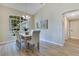 Inviting dining area with modern chandelier, views of the outdoor greenery, and vaulted ceilings at 2024 Flaming Arrow Ct, Fern Park, FL 32730