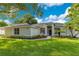 Charming single story home featuring a well-manicured lawn, garden beds, and a walkway to the front door at 2024 Flaming Arrow Ct, Fern Park, FL 32730