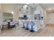 Bright, open kitchen boasts white cabinetry, stainless steel appliances, and a large island with bar seating at 2024 Flaming Arrow Ct, Fern Park, FL 32730