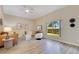 Bright living room with hardwood floors, modern furniture, and natural light from large window at 2024 Flaming Arrow Ct, Fern Park, FL 32730