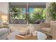 Comfortable living room with backyard view, modern decor, and neutral color palette at 2024 Flaming Arrow Ct, Fern Park, FL 32730