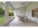 Covered patio with a glass-top table and chairs, offering views of the landscaped backyard at 2024 Flaming Arrow Ct, Fern Park, FL 32730