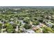 An aerial view of a neighborhood featuring mature trees, well-kept lawns, and houses with private pools at 205 Stevenage Dr, Longwood, FL 32779