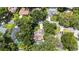 Single Gathering home aerial view surrounded by large trees and nearby neighborhood at 205 Stevenage Dr, Longwood, FL 32779