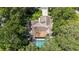 Aerial view of a screened in pool highlighting mature trees and a serene backyard at 205 Stevenage Dr, Longwood, FL 32779