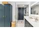 Modern bathroom with blue cabinets, marble floors, and a stylish glass enclosed shower at 205 Stevenage Dr, Longwood, FL 32779