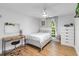 Cozy bedroom with a ceiling fan, wood floors, a light-colored bed and abundant natural light at 205 Stevenage Dr, Longwood, FL 32779