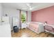 Cozy bedroom with light-colored hardwood flooring and a large window at 205 Stevenage Dr, Longwood, FL 32779