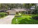 Charming single-story home featuring a manicured lawn, stone accents, and an attached two-car garage at 205 Stevenage Dr, Longwood, FL 32779