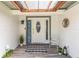 Charming front porch with a decorative door, 'WELCOME' sign, and a cozy chair, creating an inviting entrance at 205 Stevenage Dr, Longwood, FL 32779